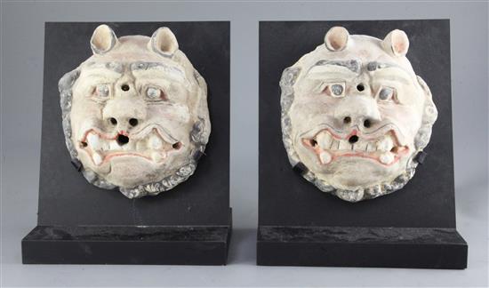 Two Chinese polychrome painted taotie masks, from Xian, Han dynasty, 206BC-220AD, height 19cm, excl. modern stands